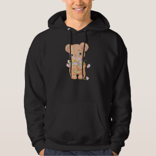 Teddybär, der einen Hoodie der Blumenstrauß-Männer