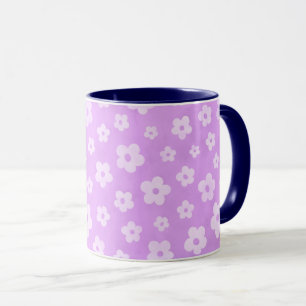 Teetasse aus lila und weißen Blume mit blauem Grif