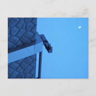 The moon hangs above the breakwater. postkarte