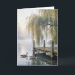 Thinking of You Lake Dock with Geese Karte<br><div class="desc">A tranquil lake features a rustic wooden dock beneath elegant willow branches in the mist,  while two Canada geese glide across the still water,  creating gentle ripples behind them. 
All text can be changed.</div>