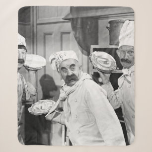 Three chefs holding pies for a fight in the kitche sherpadecke