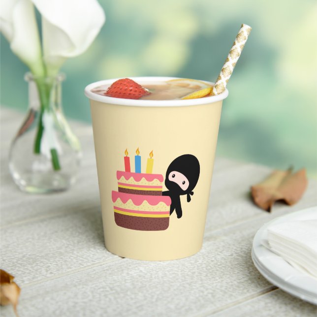 Tiny Ninja Behind Birthday Cake on Yellow Pappbecher (In Situ)