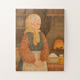 Traditionelle slawische Großmutter an einem warmen Puzzle