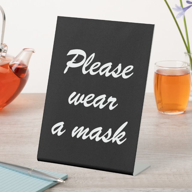 Tragen Sie eine Maske, ein schwarz-weißes, elegant Sockelschild (In Situ)