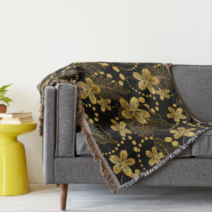 tropische Blätter und Blume in Gold auf schwarz Decke