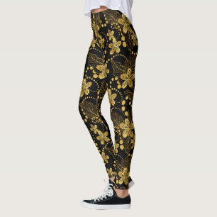 Tropische Blätter und Blume in Schwarz und Gold Leggings