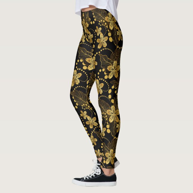 Tropische Blätter und Blume in Schwarz und Gold Leggings (Links)