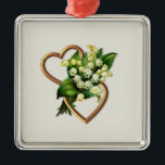 Two Romantic Hearts with White Lilies Ornament Aus Metall<br><div class="desc">This ornament has two gold entwined hearts with a lily of the valley spray. The open hearts are horizontale with the spray of flowers going through the center. You can add text and change the background color with the personalize option. You will find other items with this moor in the...</div>