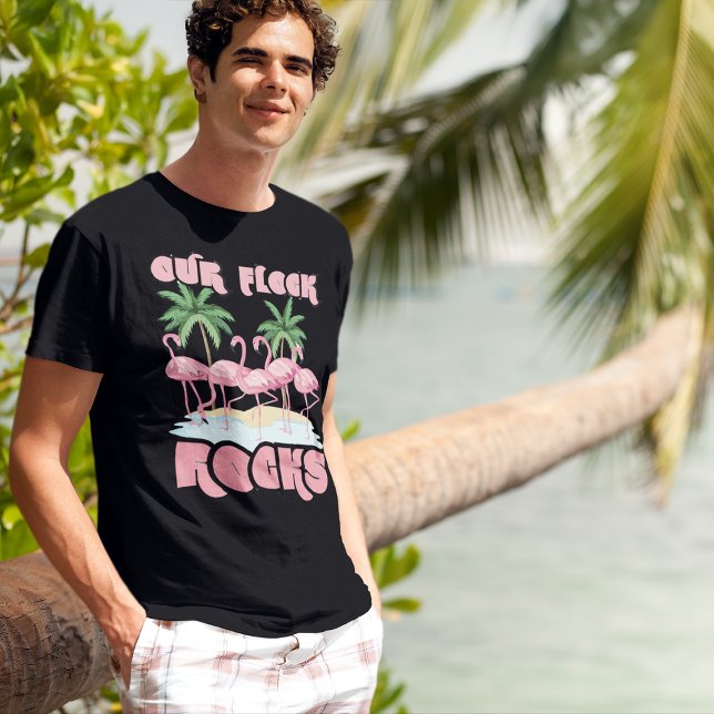 Unsere Flock Rocks Flamingos Matching Family Group T-Shirt (young man in tropical beach setting wearing pink flamingo Our Flock Rocks family reunion t-shirt)