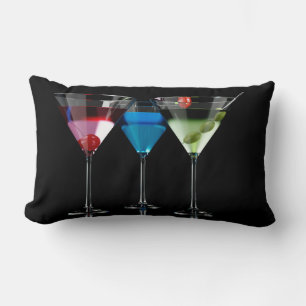Verschiedene Cocktails in Martini-Brillen auf schw Lendenkissen