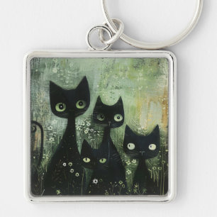 Vier schwarze Katzen mit Gänseblümchen auf gemisch Schlüsselanhänger