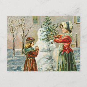 Vintage-Mutter und Mädchen beim Schneemannbauen Feiertagspostkarte