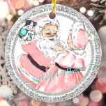 Vintage Pink Santa   Mrs Claus Victorian Christmas Keramik Ornament<br><div class="desc">a distressed and weathered old world style and mrs. claus dancing gleefully with a Santa Holding in a mint green glove and both dressed in beautiful vintage shabby chic blush pinks tones, surrounded by silver antique victorian frame framework dress botess of this ceramic round mas tree ornament. change the text...</div>
