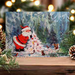 Vintage Santa- und Waldtiere Niedlich Retro Feiertagspostkarte<br><div class="desc">Vintage Santa und Woodland Tiere Niedlich Retro Urlaub Postkarte. Dieses Design zeigt eine Vintage Szene mit dem Weihnachtsmann und Waldtieren im Wald,  die einen Weihnachtsbaum schmücken. Was für eine schöne Retro-Urlaubsszene.</div>