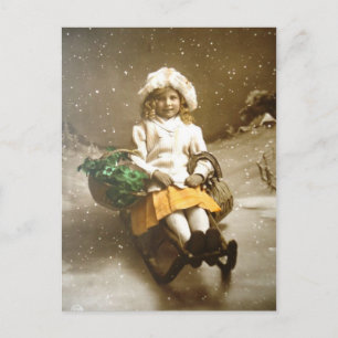 Vintage viktorianisches Mädchen auf einem Schlitte Postkarte