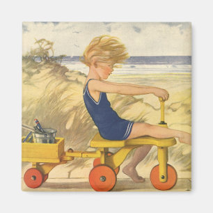 Vintager Junge spielt am Strand mit Sandspielzeug Magnet