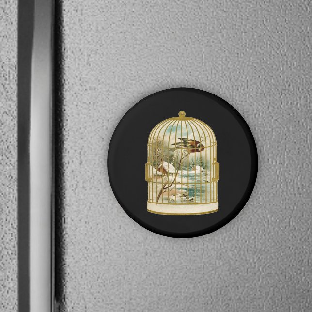 Vogel im Käfig Winterlandschaft Magnet (Golden birdcage with winter cabin scene inside bird on branch on black round magnet.)