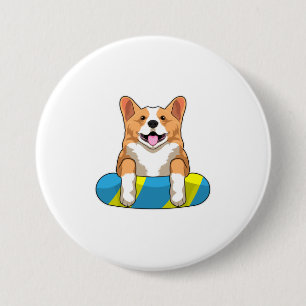 Walisischer Corgi im Schwimmen mit Brett Button