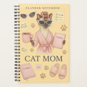 Weibliche Katze hält Terminkalender Planer