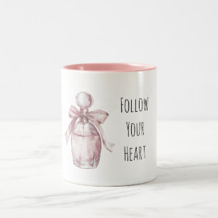 Weibliche rosa Parfümflasche mit Schleife Zweifarbige Tasse