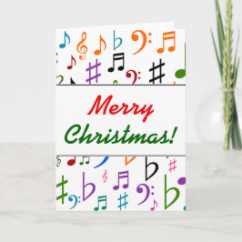 Weihnachten; viele farbenfrohe Musiknoten und Symb Feiertagskarte