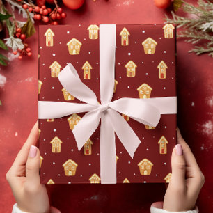 Weihnachts-Haus Gingerbrett auf dunkelrotem Hinter Geschenkpapier