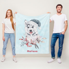 Weihnachts-Husky-Hund in einer Weihnachtsmannmütze Fleecedecke