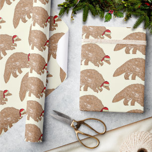 Weihnachts-Pangolin Eine Weihnachtsmannmütze trage Geschenkpapier