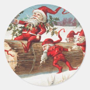 Weihnachts-Santa-Elfen rutschen auf einem Baumstam Runder Aufkleber