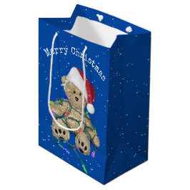Weihnachts-Teddy-Bär in getrübten Lichtern Mittlere Geschenktüte