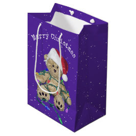 Weihnachts-Teddy-Bär in getrübten Lichtern Mittlere Geschenktüte