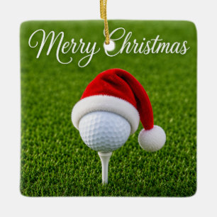 Weihnachtsgolfball mit Santa-Hut auf Tee auf Grün Keramikornament