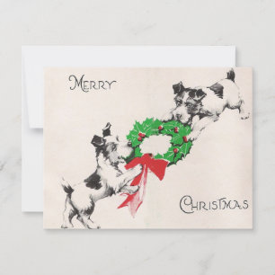 Weihnachtshunde spielen mit Kranz Feiertagskarte