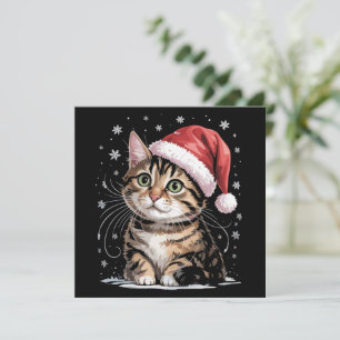 Weihnachtskatzenschnee Weihnachtsmannmütze Winter Feiertagskarte