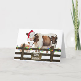 Weihnachtskühe mit Weihnachtsmannmütze Feiertagskarte