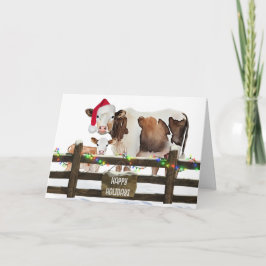 Weihnachtskühe mit Weihnachtsmannmütze Feiertagskarte