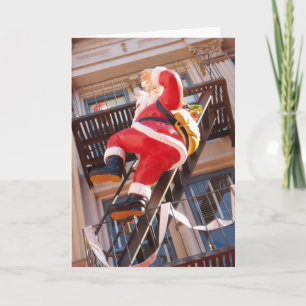 Weihnachtsmann auf der Feuerleiter Feiertagskarte
