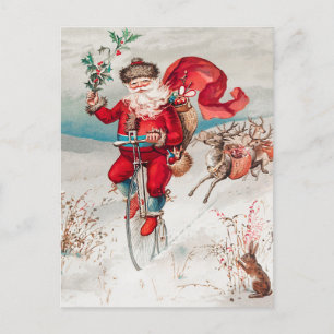Weihnachtsmann fährt Fahrrad, Rentiere und Kaninch Feiertagspostkarte