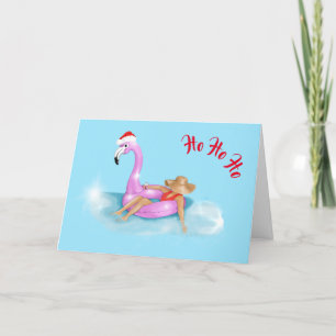 Weihnachtsmannmütze auf einem rosa Flamingo-Schwim Karte