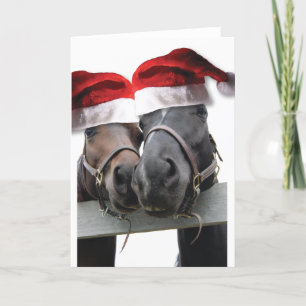 Weihnachtspferde mit Weihnachtsmannmützen Feiertagskarte