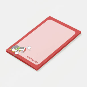 Weihnachtspinguin bekommt eine Schneeball Post-it Klebezettel