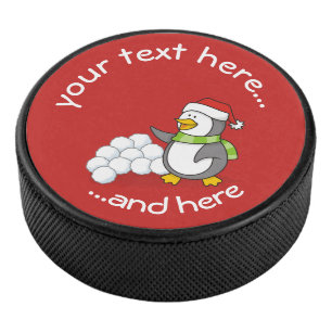 Weihnachtspinguin mit Schneebälle schwingen Eishockey Puck