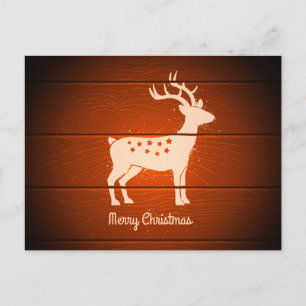 Weihnachtsrentier auf Holzhintergrund Feiertagspostkarte