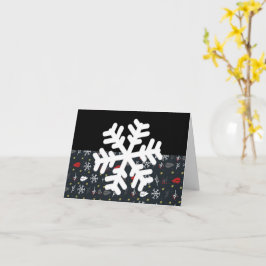Weihnachtsschneeflocken und Blätter mit schwarzer  Karte