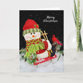 Weihnachtsschneemann auf Schlitten Feiertagskarte