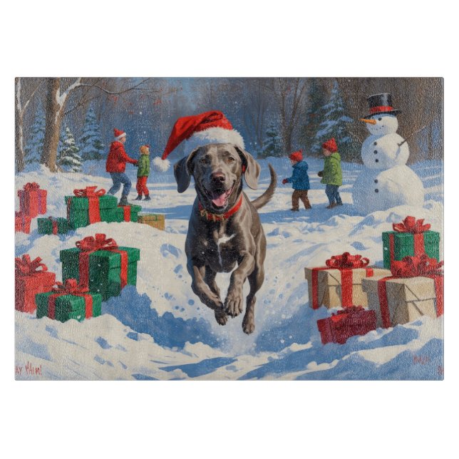 Weimaraner läuft im Schnee mit Weihnachtshut Schneidebrett (Vorderseite)