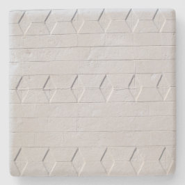 Weiße, gestrichene Mauer, quadratischer Untersetze Steinuntersetzer