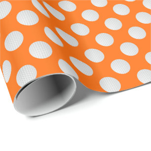 Weiße Golfbälle auf Orange Geschenkpapier