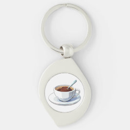 Weiße Kaffeetasse auf einem Unterteller gefüllt mi Schlüsselanhänger