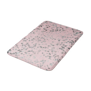 Weiße Silbersteine auf Rosa Badematte
